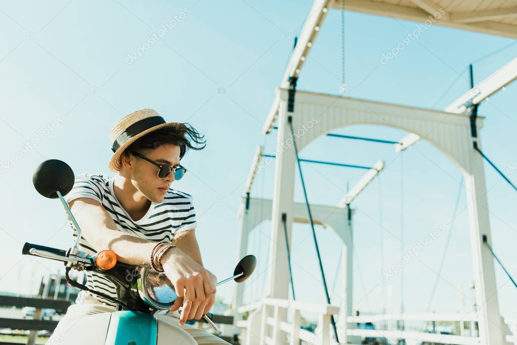 man sitting on scooter