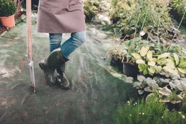 gardener in rubber boots with spade clipart