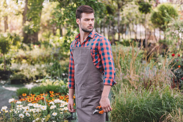 gardener with pruning shears in garden