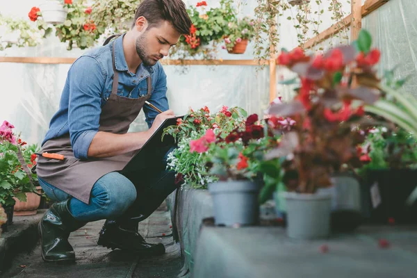 Gardener making notes during work — Stock Photo, Image