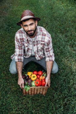 farmer holding basket with vegetables clipart