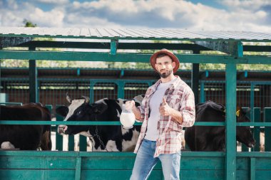 farmer with fresh milk in stall clipart