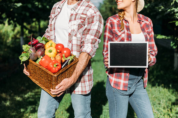 farmers with harvest and chalkboard