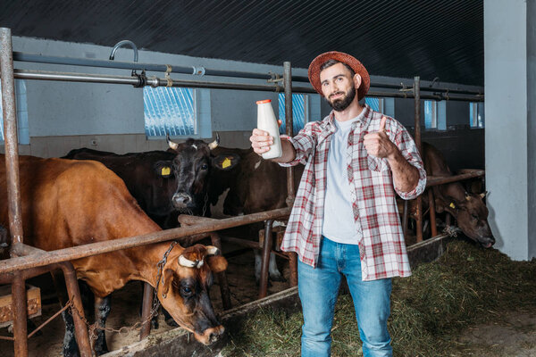 farmer with fresh milk in stall