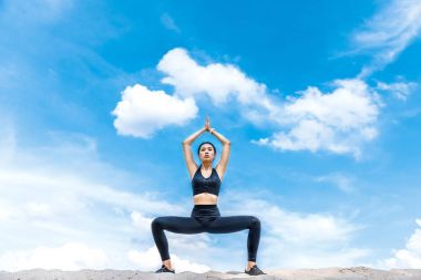 woman practicing yoga clipart