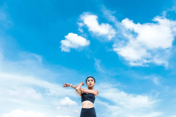 Sportswoman stretching hands — Stock Photo, Image