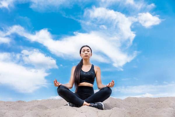 woman meditating in lotus yoga pose
