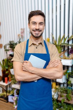 male florist with digital tablet