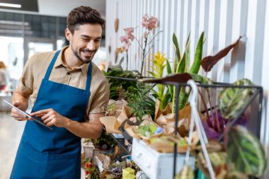 male florist with digital tablet clipart