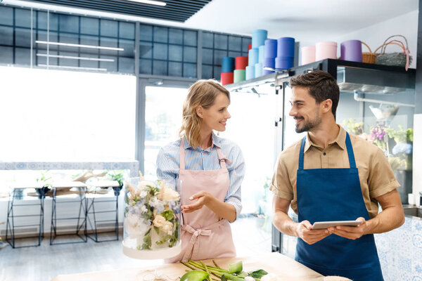 florists with digital tablet in flower shop