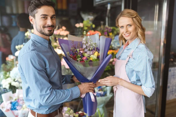 Florista e comprador com buquê — Fotografia de Stock