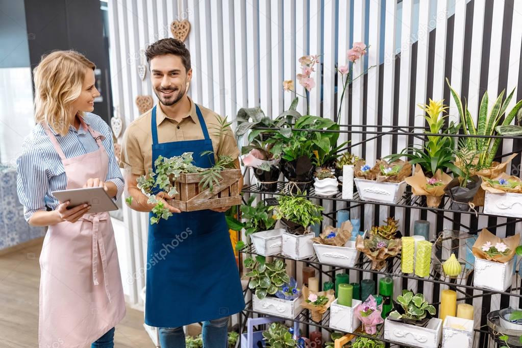 florists with digital tablet in flower shop