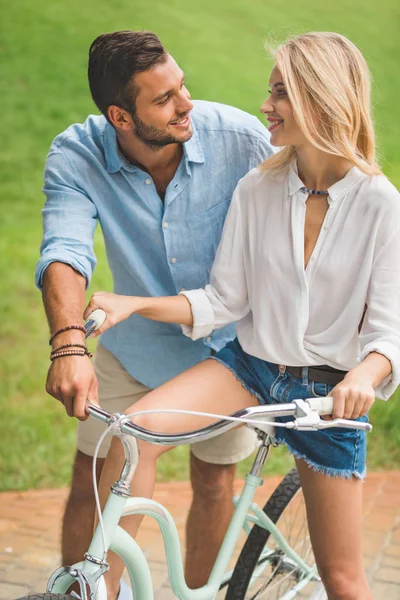 Smiling couple with bicycle — Stock Photo, Image