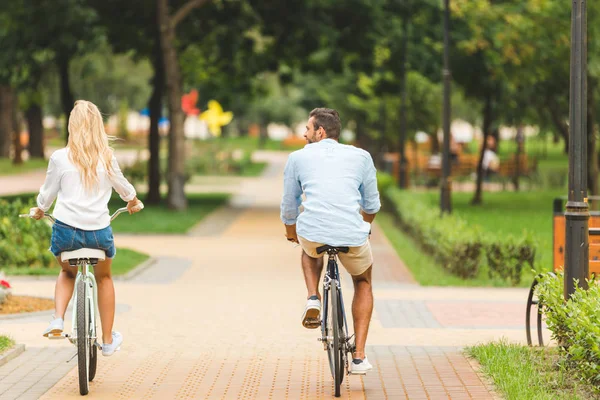 Paar paardrijden fietsen in park — Stockfoto