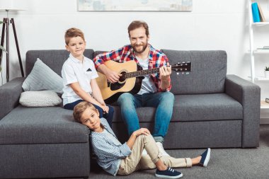 father with sons playing guitar clipart