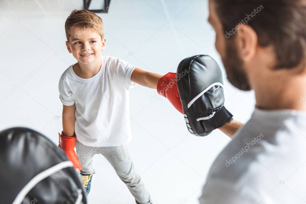 father and son boxing together