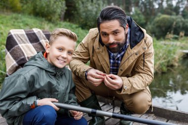 father and son fishing with rod clipart