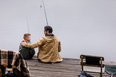 father and son fishing together clipart