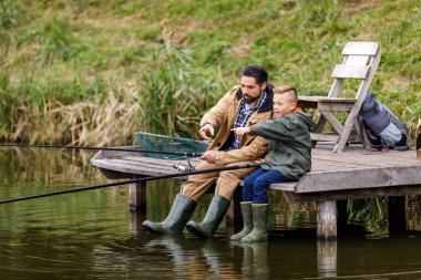 father and son fishing together clipart