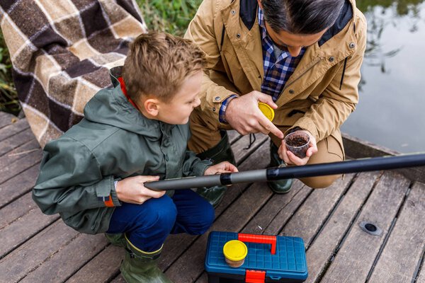 father and son with fishing rod