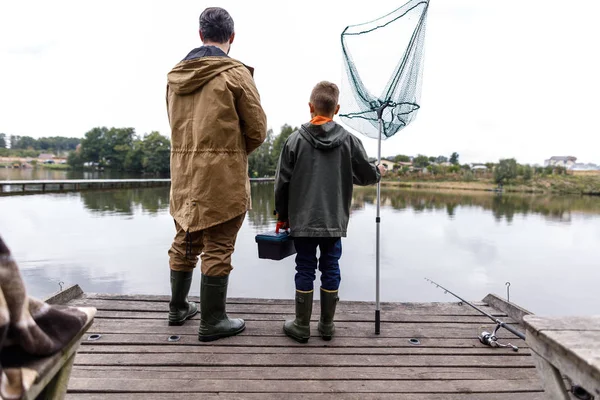 Padre e hijo pescando con caña y red —  Fotos de Stock