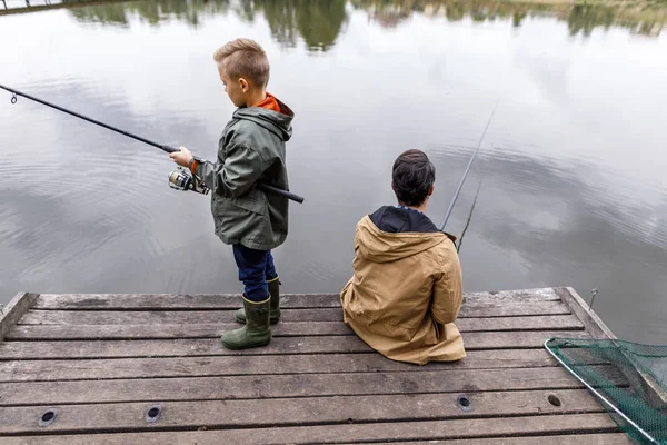 Father and son fishing with rods — Stock Photo, Image