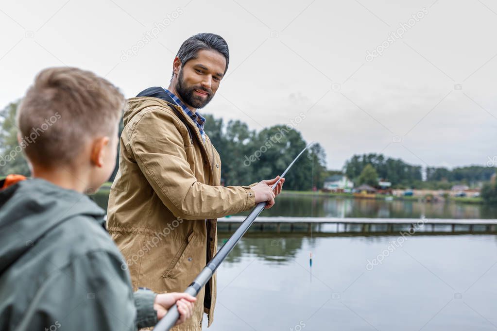 father and son fishing on lake