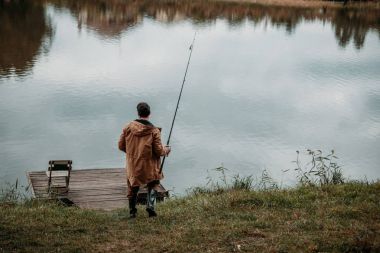 fisherman fishing with rod clipart