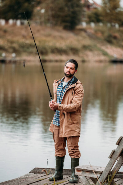 man fishing with rod 