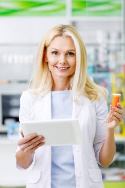 pharmacist with digital tablet and medication clipart