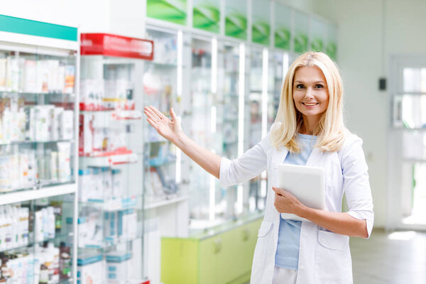 pharmacist with digital tablet in drugstore