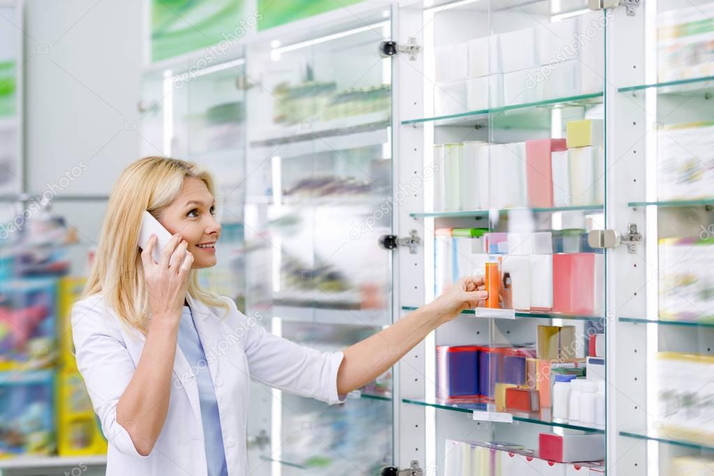 pharmacist talking on smartphone