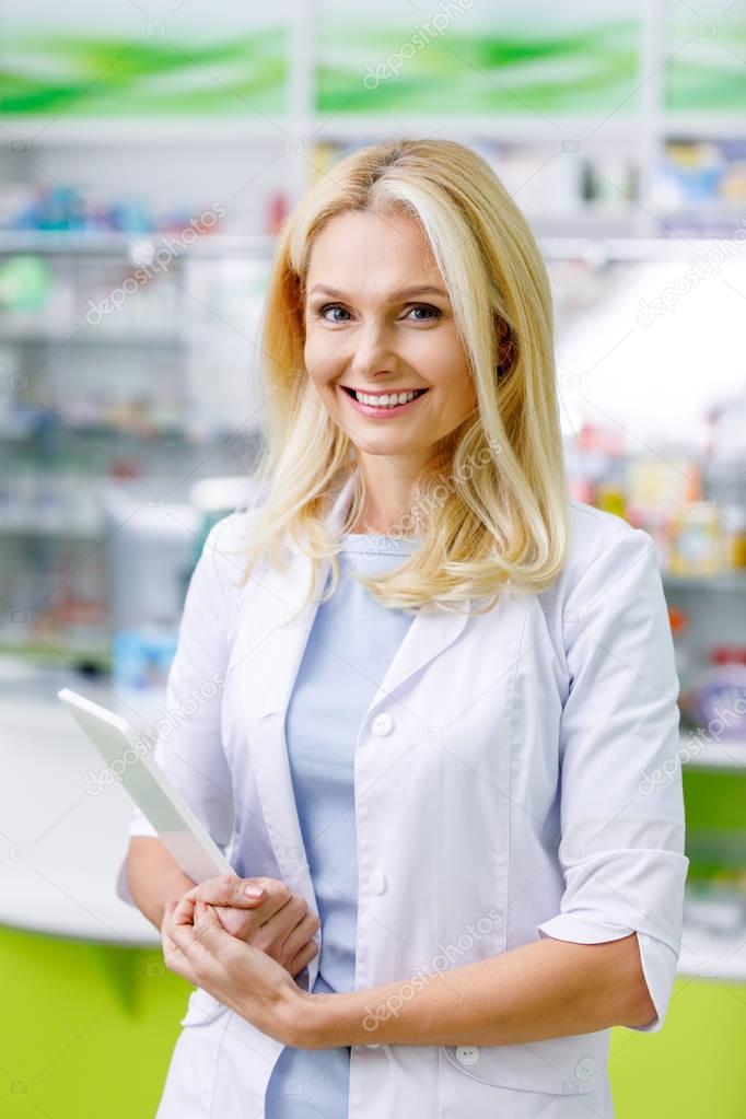 pharmacist with digital tablet in drugstore