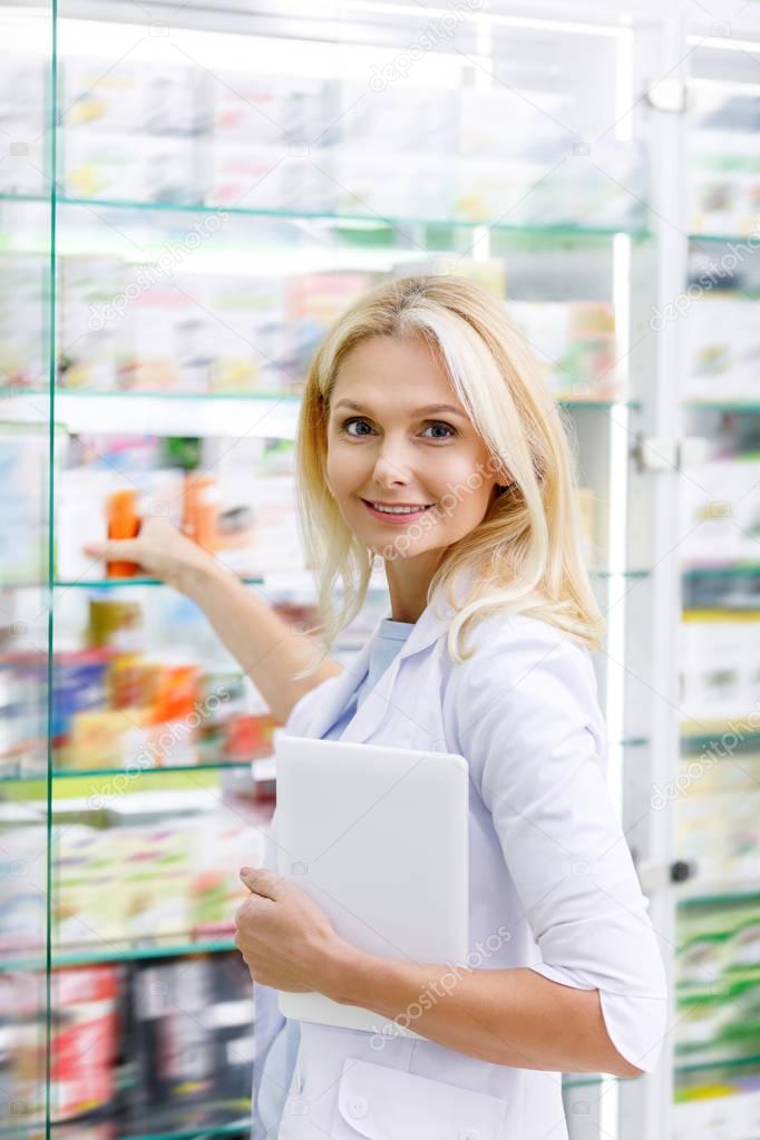 pharmacist with digital tablet in drugstore