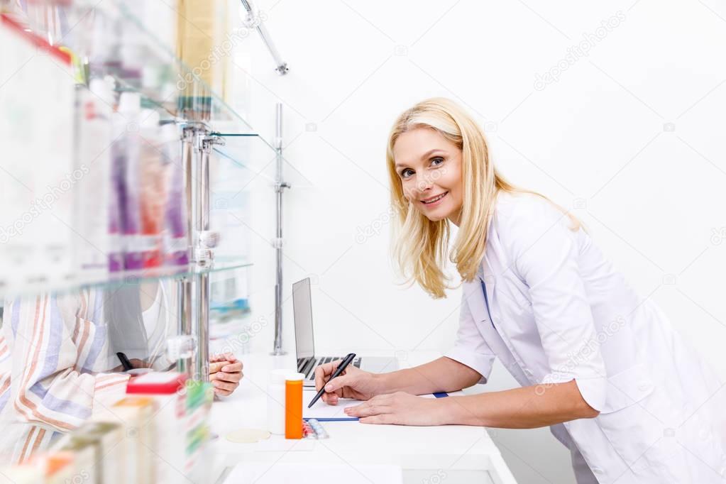 pharmacist and customer in drugstore