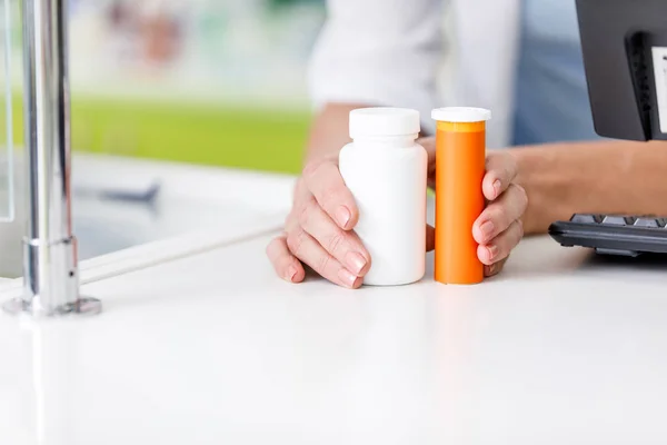 Farmacista che tiene contenitori con farmaci — Foto Stock