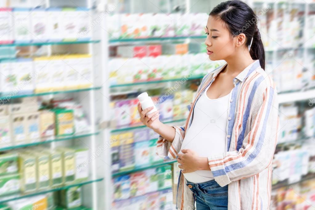 pregnant woman buying medication