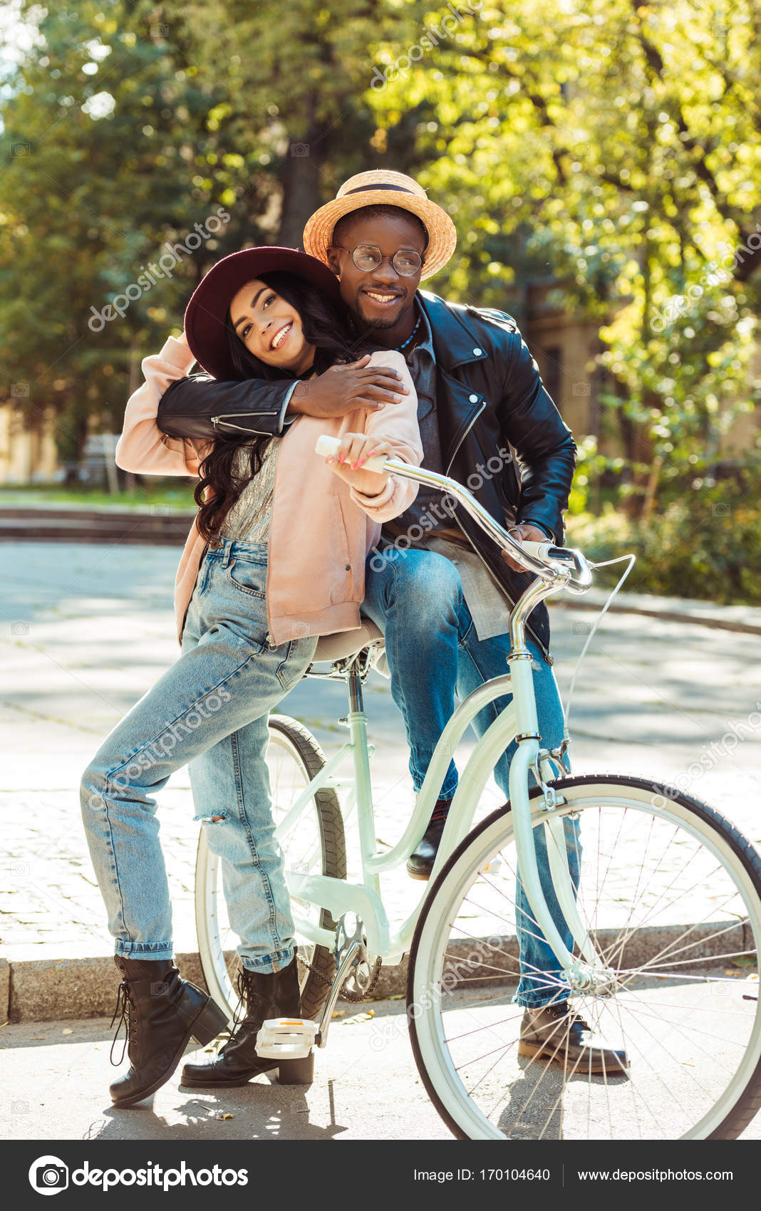 Boyfriend standing with bike and hugging girlfriend — Stock Photo