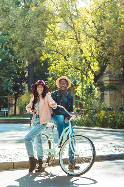 Couple standing together with bicycle — Free Stock Photo