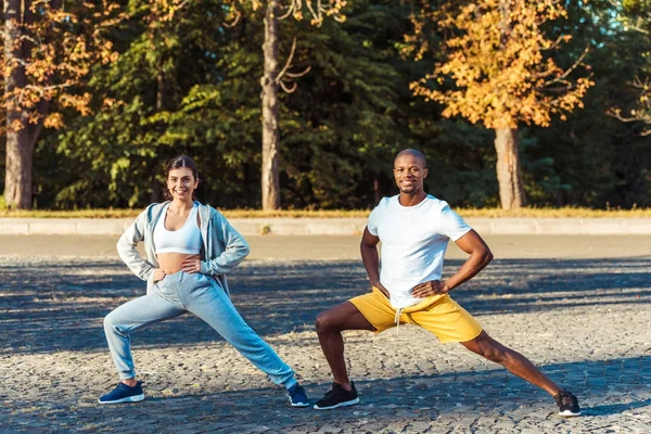 Couple stretching on road — Stock Photo, Image
