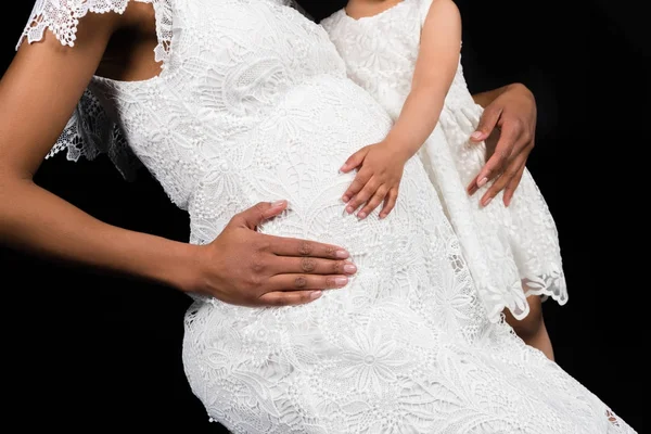 Daughter touching mothers belly — Stock Photo, Image
