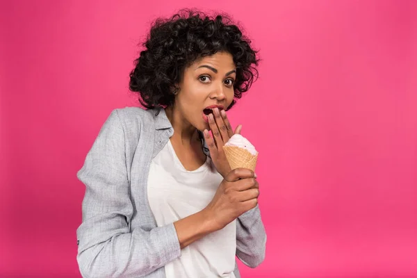 Surprised woman holding ice cream — Stock Photo, Image