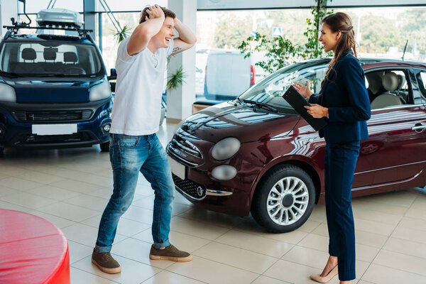 manager showing to customer car he won