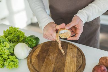 Man slicing potato clipart