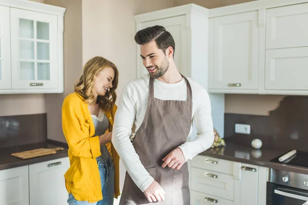 Young couple with aprons — Stock Photo, Image