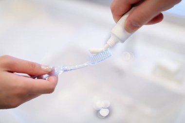 cropped image of boyfriend applying tooth paste on girlfriend tooth brush clipart