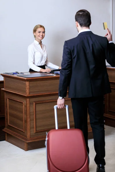 Rear View Businessman Showing Credit Card Receptionist Hotel — Stock Photo, Image