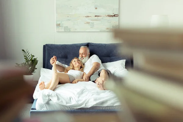 Couple relaxing on bed — Stock Photo