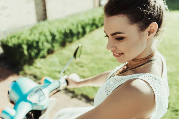 Woman sitting on scooter — Stock Photo