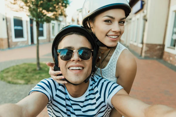 Jeune couple dans les casques prendre selfie — Photo de stock
